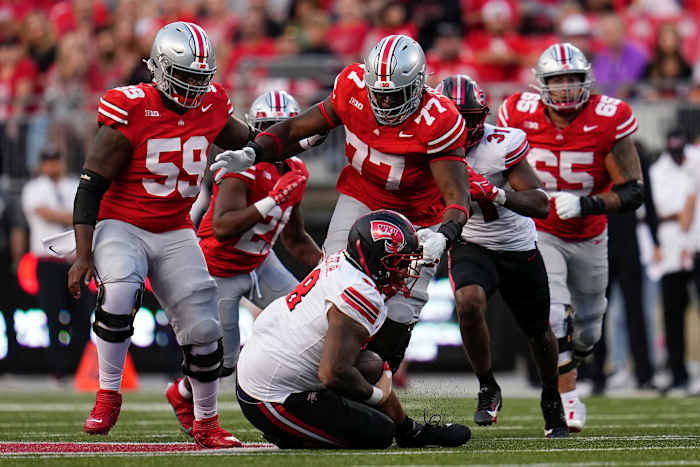 Ohio State Buckeyes offensive lineman Tegra Tshabola (77) goes to tackle Western Kentucky Hilltoppers defensive tackle Hosea Wheeler (98) during the NCAA football game at Ohio Stadium.
